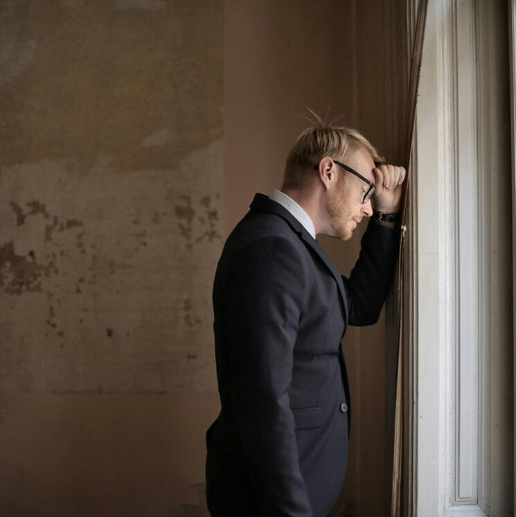 Man with anxiety looking out the window