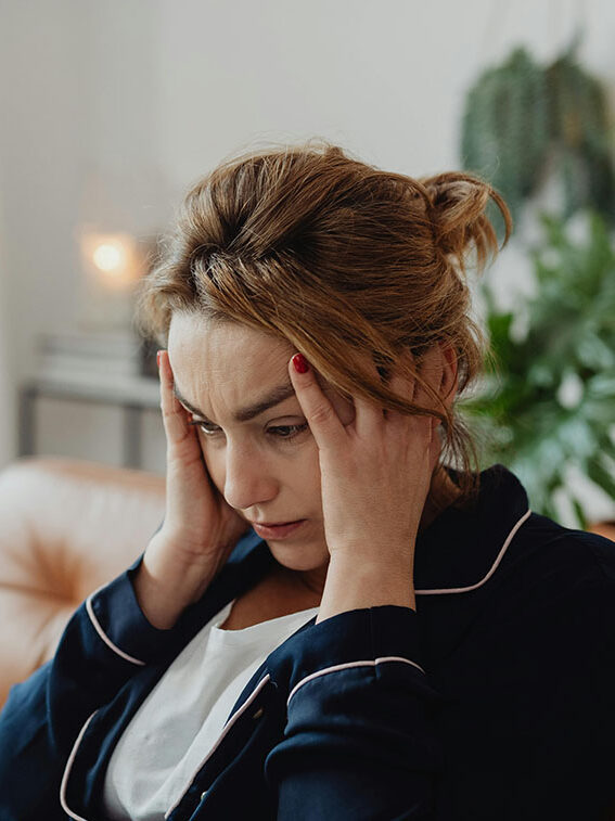 woman with anxiety, head in hands